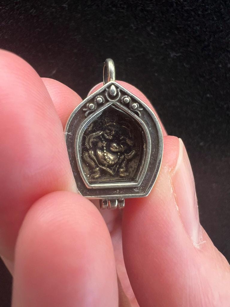 Tiny Dzambhala Ghau Pendant | Metal and Glass | Approx 3/4in x 1/2in | Tibet | Gau