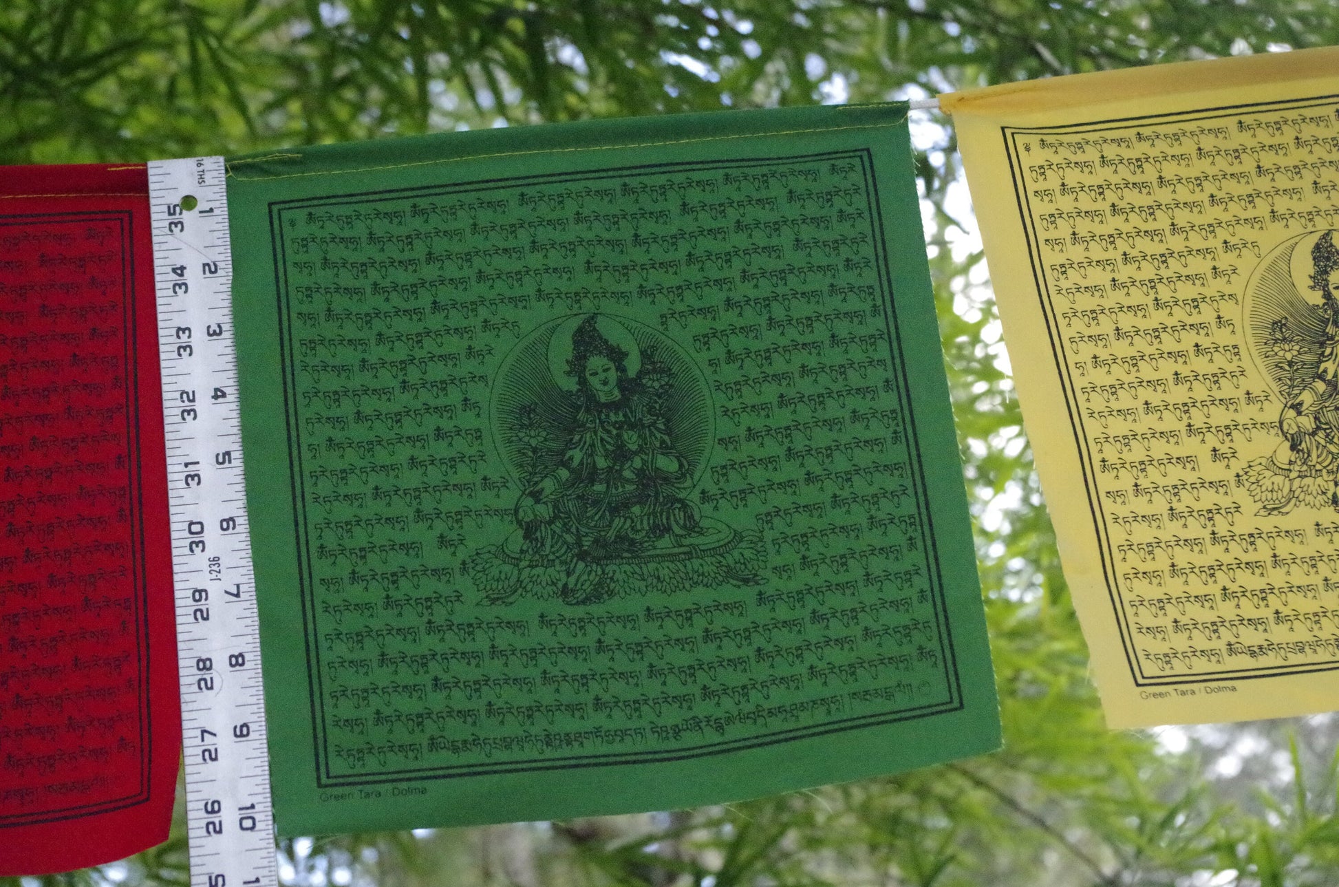 High-quality Green Tara prayer flag from 5-color set of 10, 10x10 in each. Imprinted in black ink with revered image of female Buddha of Compassion.