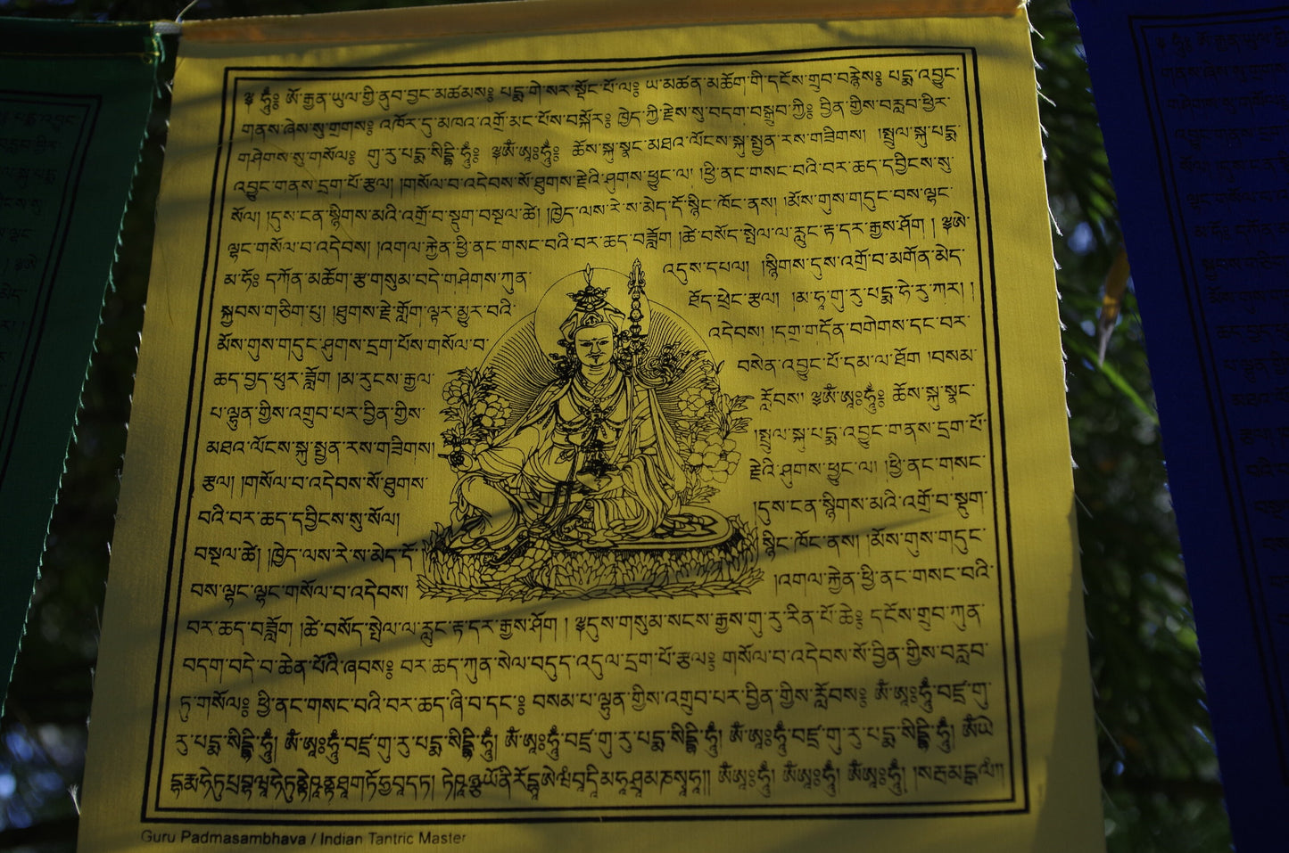 High-quality Guru Padmasambhava prayer flag from 5-color set of 10, 10x10 in each. Imprinted in black ink.