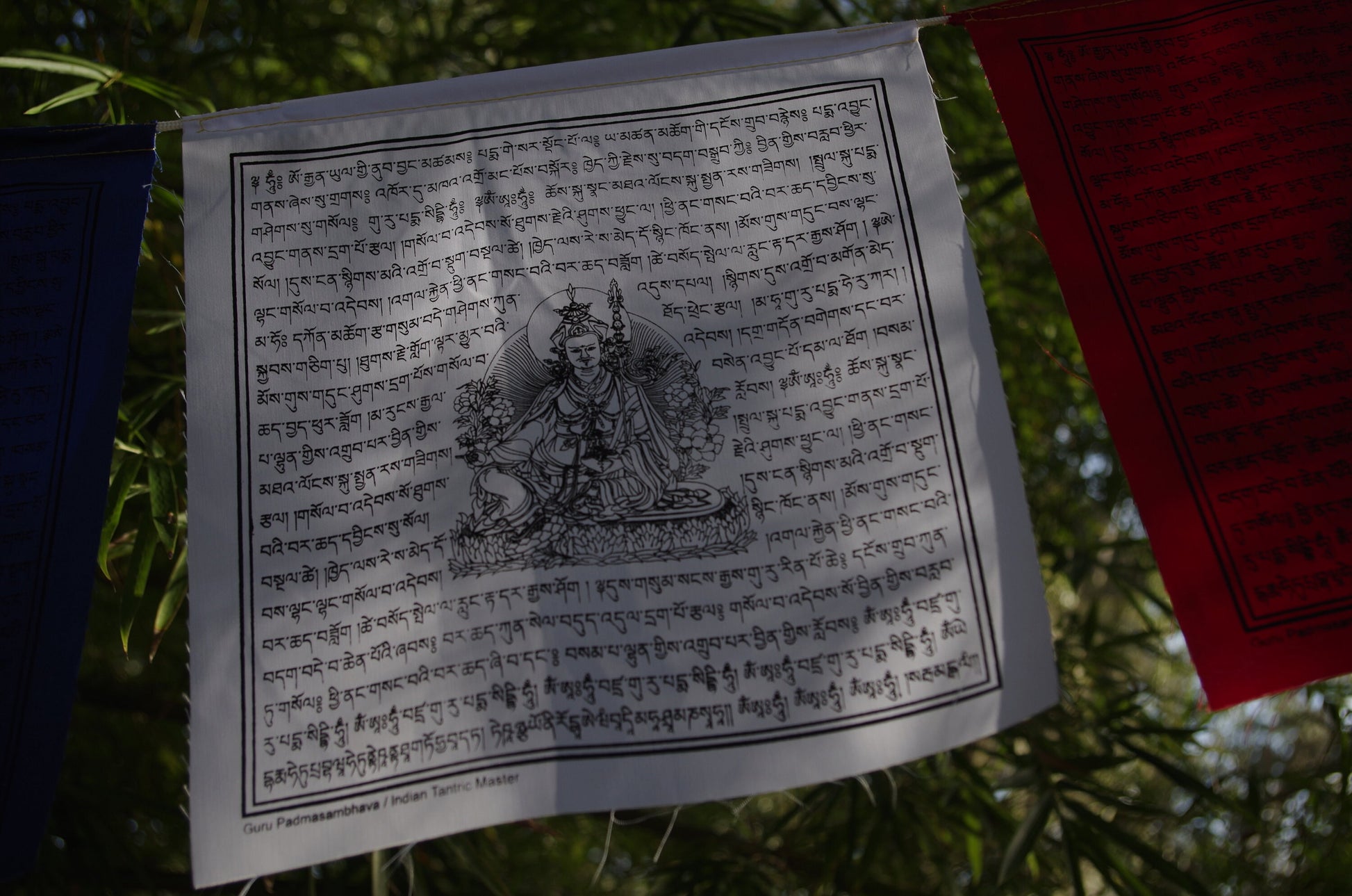 High-quality Guru Padmasambhava prayer flag from 5-color set of 10, 10x10 in each. Imprinted in black ink.