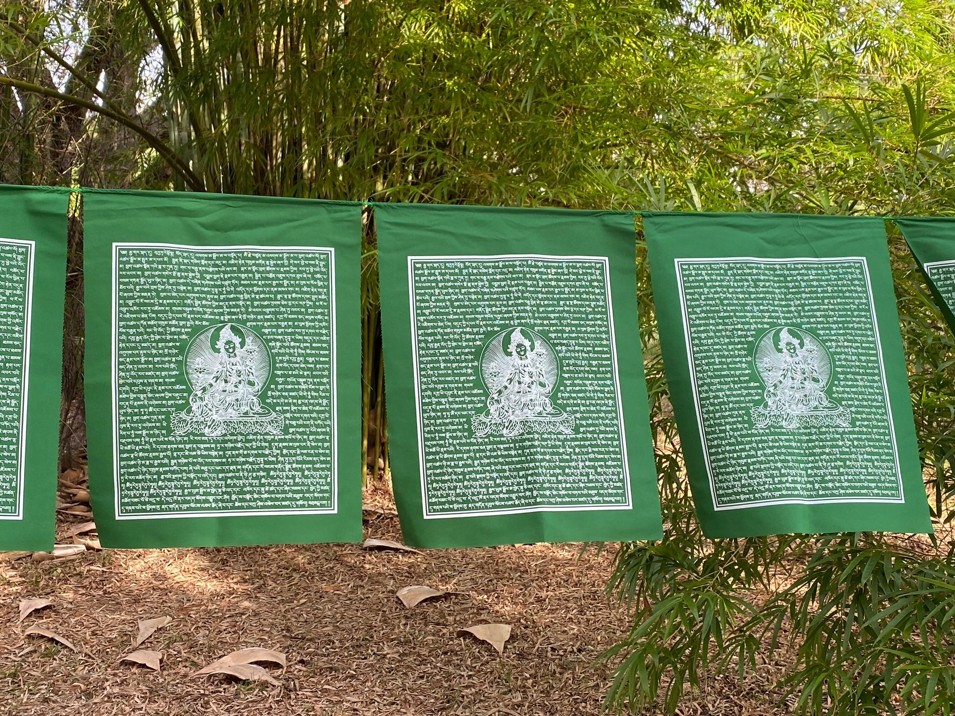 High-quality 14x17 Green Tara prayer flags on green cloth, printed in white ink. Part of a set of 25 flags.
