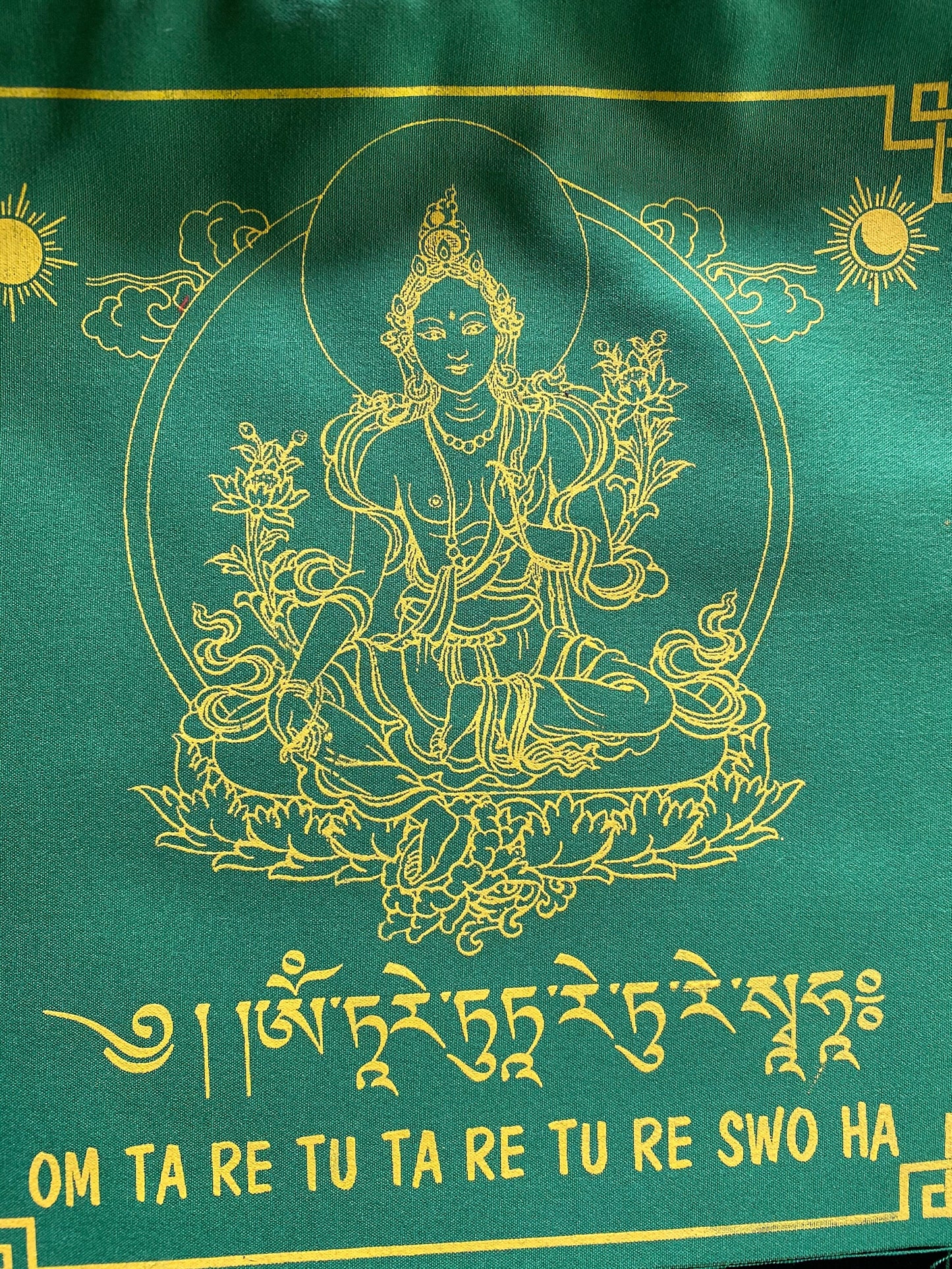 High-quality Tibetan prayer flags: Close-up of 1 Green Tara flag from a set of 10, 8x8 inches each, colored green, imprinted with her image in yellow ink.
