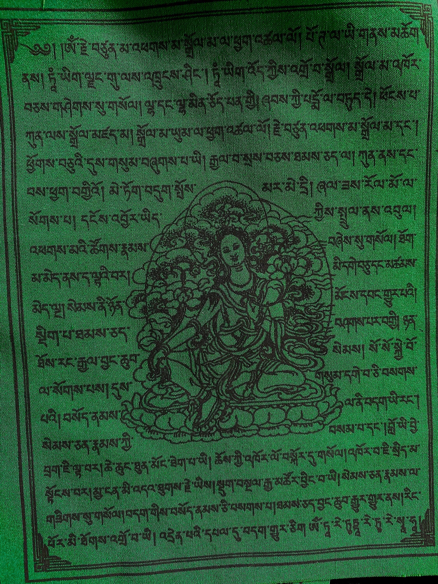 A Green Tara flag from 10-flag strand of high-quality Tibetan prayer flags. Measuring 6x7.5 inches, imprinted with black ink, ideal for indoor/outdoor use.