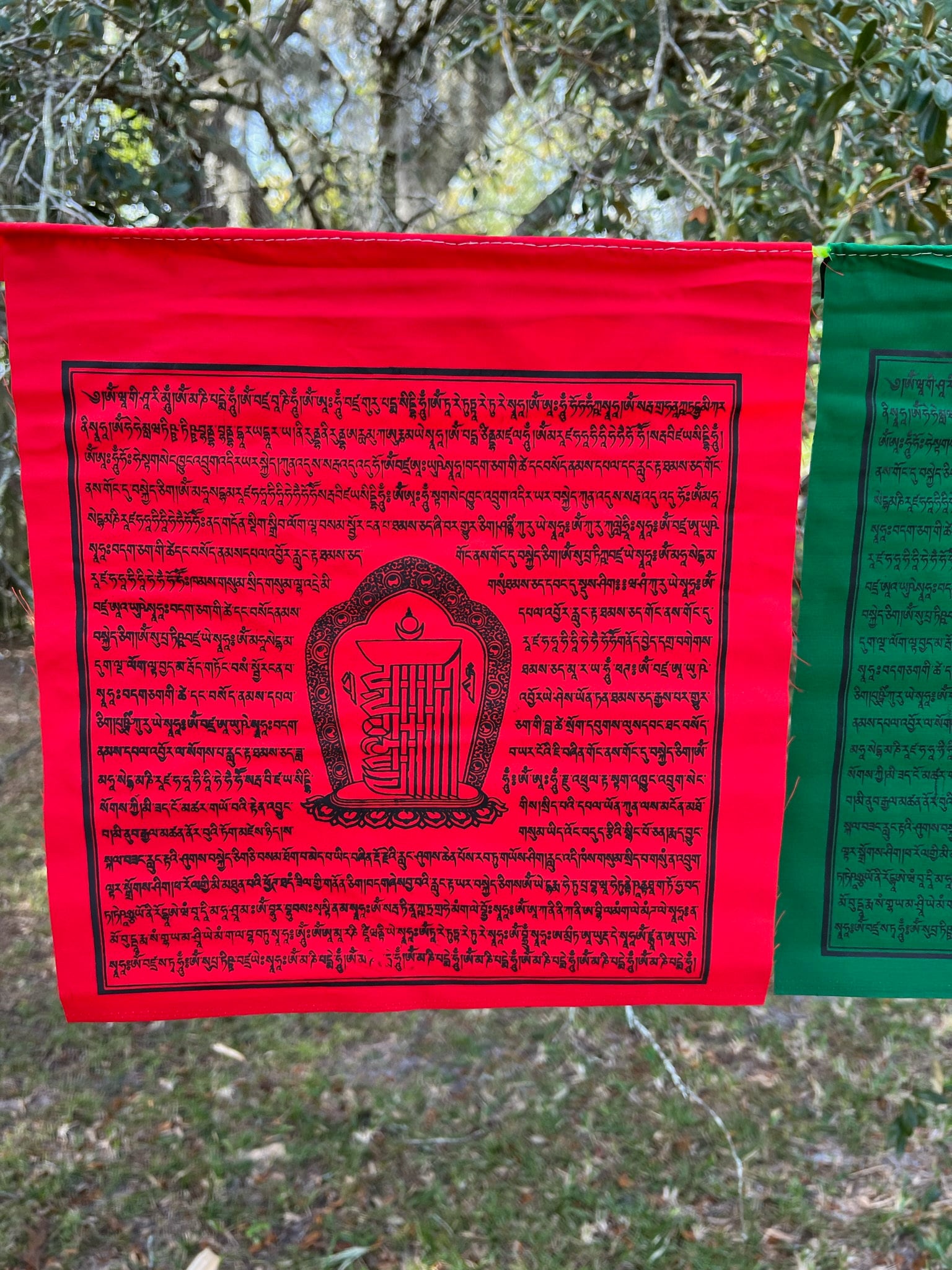 Shimmering red Kalachakra prayer flag, 13&quot;x13&quot; from a 25-flag strand. 5 colors, imprinted with prayers & 10-fold seed syllable.
