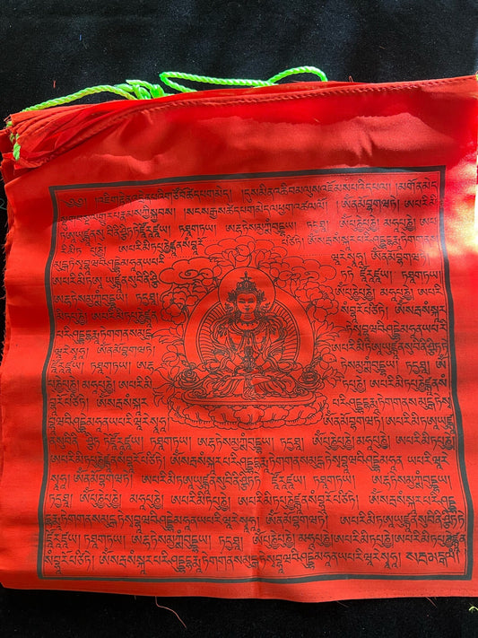 A single red Amitayus prayer flag on a black velvet background